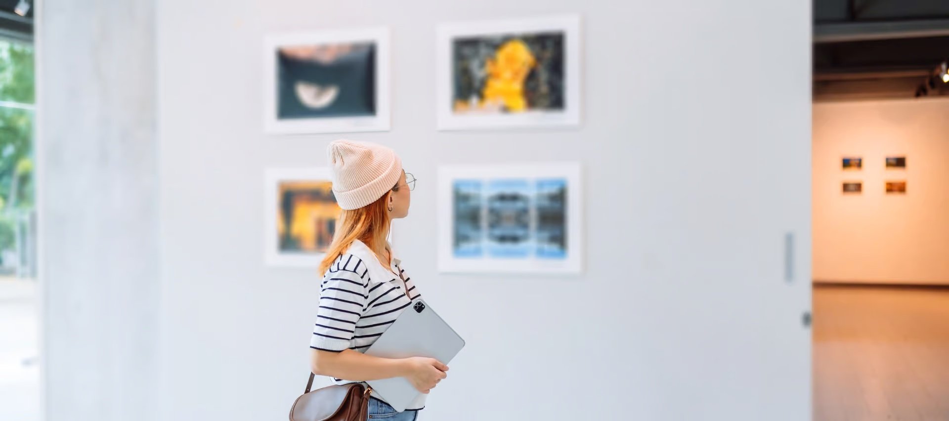 young woman looking at art in gallery